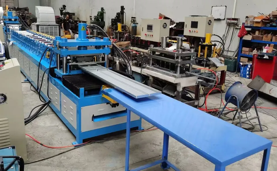 Light-gauge steel stud and track roll forming machine with cutoff station in the workshop.