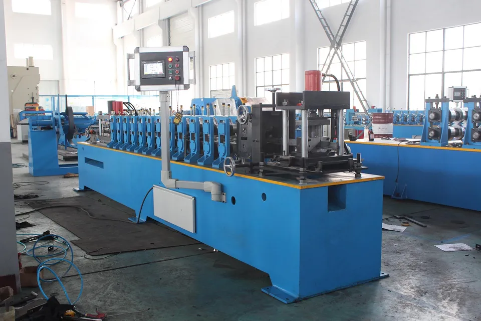 Blue roller stands and a control panel along a workshop machine bed
