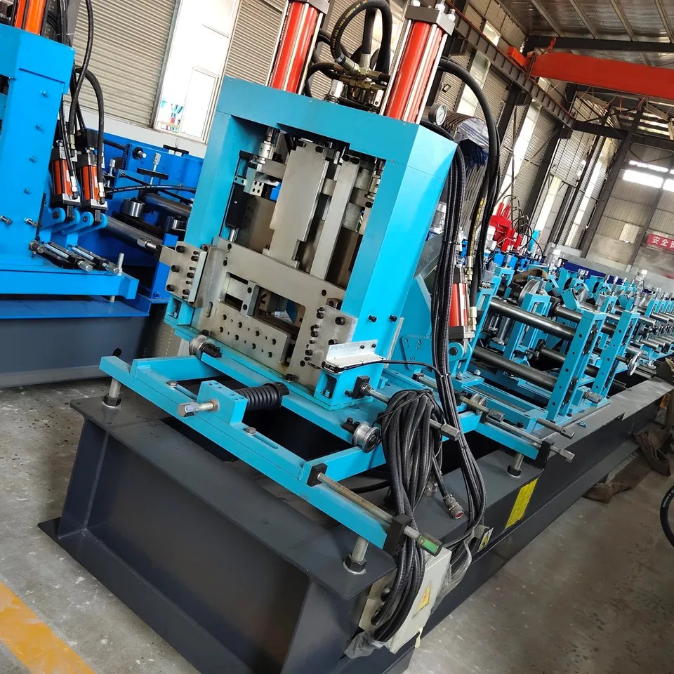 Workshop view of a hydraulic press station on a forming line. It is not a photograph of a named highway guardrail model and does not show a highway installation.